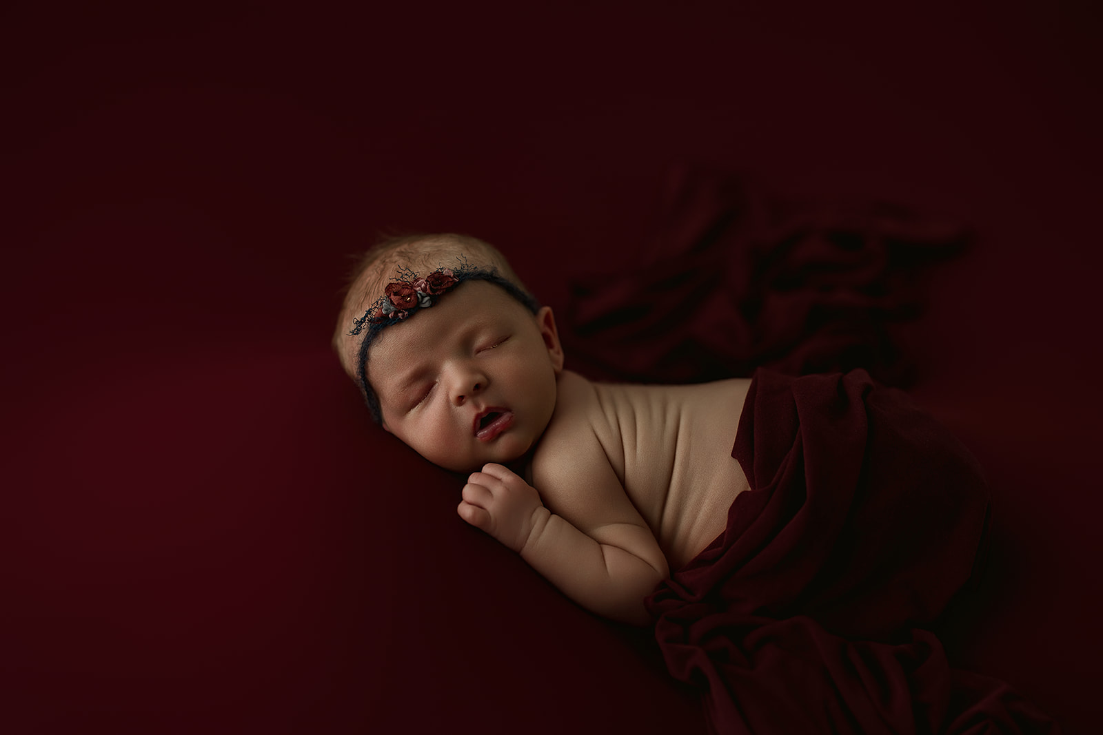 sleepy newborn baby photographed at 8 days old in studio